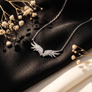 Minimalist silver necklace featuring polished angel wings pendant, a graceful protection necklace and faith necklace crafted from S925 sterling silver. Lightweight design rests softly on the collarbone, a delicate necklace for her built for everyday elegance, weddings, and special occasions alike.