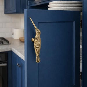 May include: A set of three ceramic mugs with a speckled, matte finish. The mugs are in shades of cream, light gray, and dark gray. Each mug has a simple, minimalist design and a rounded handle. Perfect for coffee or tea.