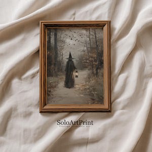May include: A framed wall art print featuring a figure in a dark cloak and pointed hat walking through a misty, autumnal forest whilst holding a glowing lantern. The scene includes bare trees and a flock of birds in the sky. The text SoloArtPrint is visible.