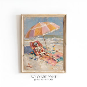 May include: A framed art print depicting a skeleton wearing sunglasses, reclining on a beach chair under a pink and orange striped umbrella. The scene includes a beach towel, a tropical drink with a straw, and seashells on the sand.