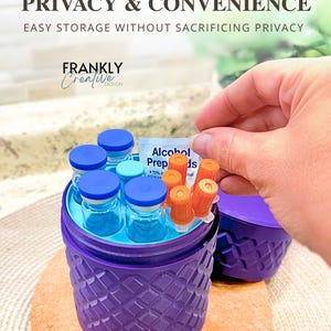May include: A purple cylindrical storage container with a textured diamond pattern on the exterior. The container holds several small glass vials with blue caps, orange-capped needles, and an alcohol prep pad. The text reads Optimized Storage.