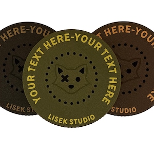 May include: Three circular patches in shades of brown and olive green. Each patch features the text "YOUR TEXT HERE" in a contrasting colour, encircling a fox face design. The text "LISEK STUDIO" is also visible.