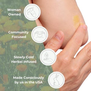 Puede incluir: Primer plano de un brazo aplicando un b&aacute;lsamo herbal amarillo. El texto dice "Woman Owned", "Community Focused", "Slowly Cold Herbal Infused" y "Made Consciously by us in the USA".