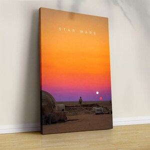 May include: A rectangular canvas wall art print featuring a desert landscape at sunset with a gradient sky transitioning from orange to purple. A lone figure stands in the distance near a domed structure. The text STAR WARS is printed in white.