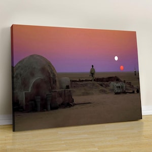 May include: A rectangular canvas wall art print depicting a desert landscape at sunset with a purple and orange sky. A lone figure stands in the distance near a domed structure, while two suns, one white and one red, are visible on the horizon.