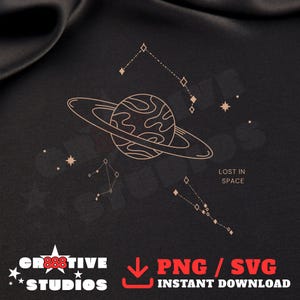 May include: A digital illustration featuring a planet with rings, constellations, and the text "LOST IN SPACE" in a minimalist style. The design is in shades of beige on a dark background, with the text "PNG / SVG INSTANT DOWNLOAD".