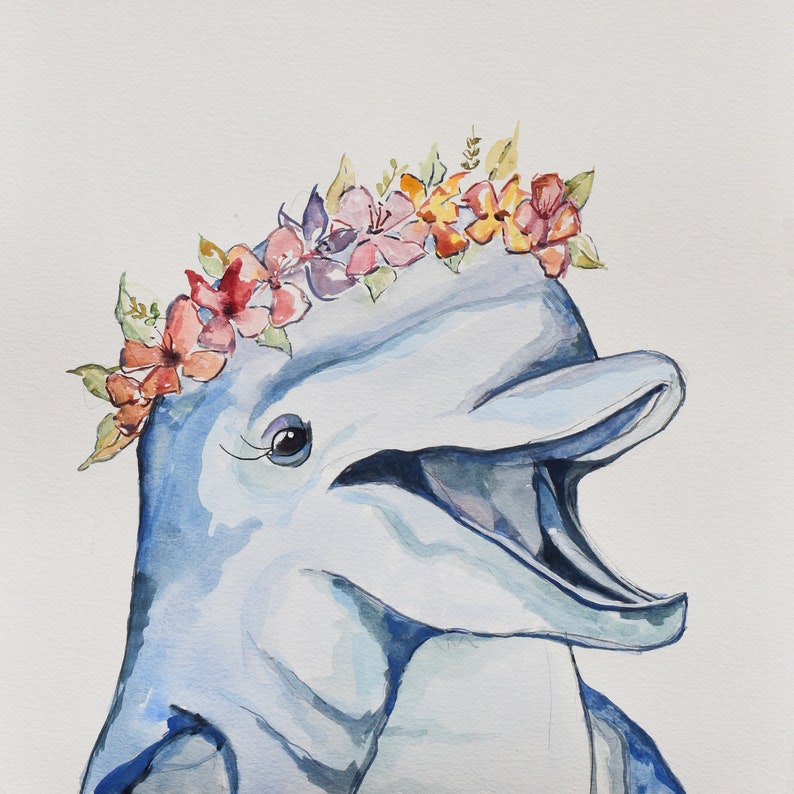 May include: A watercolor painting of a dolphin wearing a flower crown. The dolphin is light blue and has a pink mouth. The flower crown is made of pink, red, and orange flowers.