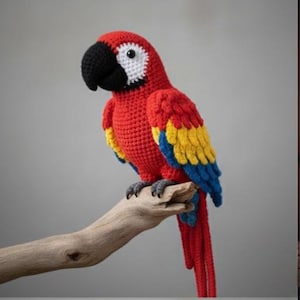 May include: A handmade crochet parrot in vibrant red, yellow, and blue perched on a wooden branch. The bird features a black beak, white eye accents, and detailed feathering. This decorative item is a unique piece of home decor.