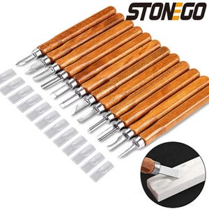 May include: A set of wood carving tools with various blade shapes. The tools have wooden handles and metal blades, with protective plastic covers. The brand name "STONEGO" is visible in the top right corner.