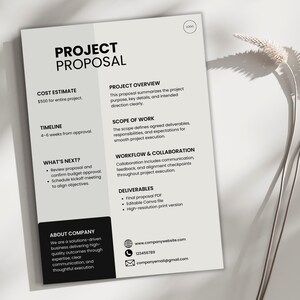 May include: A project proposal document with the title "PROJECT PROPOSAL" in bold black text. The document includes sections for cost estimate, timeline, and deliverables. The document is on a white background with a shadow.