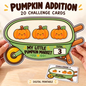 May include: A large die-cut card shaped like a green wheelbarrow containing three orange cartoon pumpkins with smiling faces. The text reads PUMPKIN ADDITION 20 CHALLENGE CARDS, MY LITTLE PUMPKIN MARKET, and TOTAL 3. A smaller rectangular card shows CHALLENGE 1.