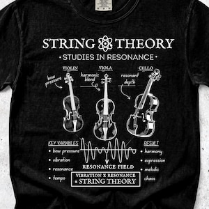May include: Black t-shirt with a white graphic featuring three stringed instruments: a violin, viola, and cello. The text reads "STRING THEORY - STUDIES IN RESONANCE" with additional scientific diagrams and text.
