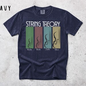 May include: Navy blue t-shirt featuring the words "STRING THEORY" above four coloured rectangles, each with a stringed instrument silhouette. The instruments are labelled violin, viola, cello, and bass. The word "NAVY" is in the upper left corner.