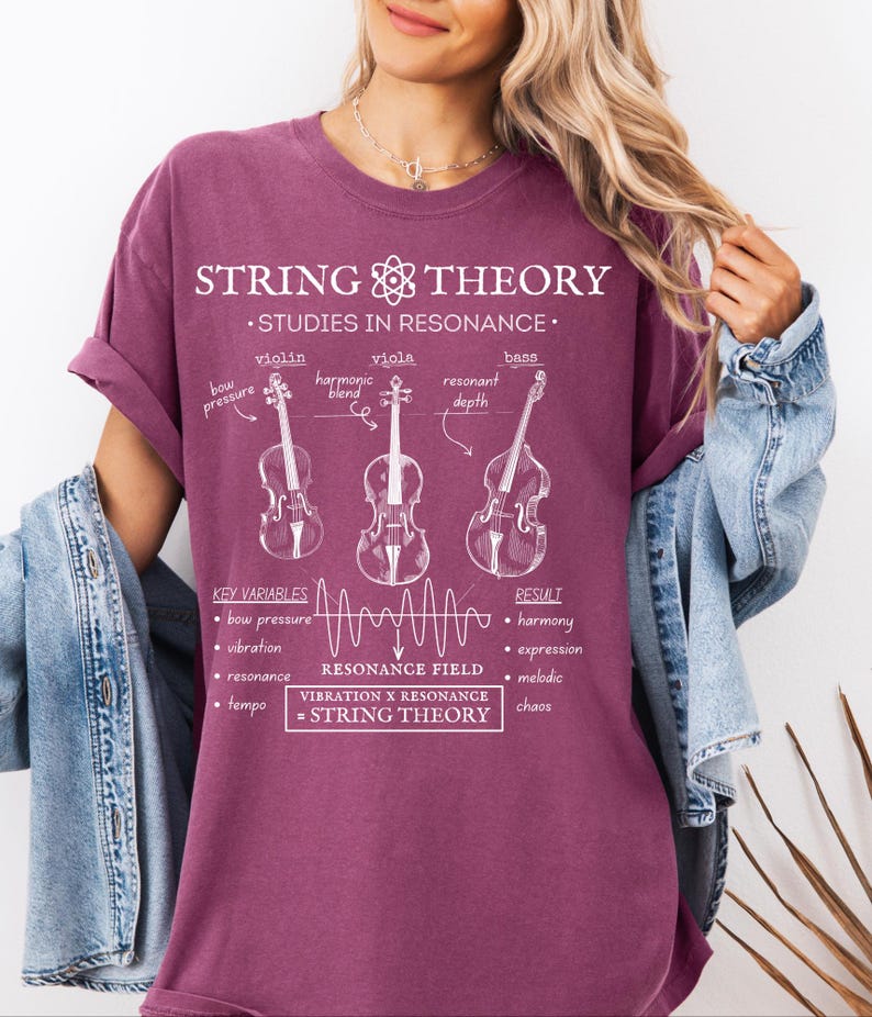 May include: A maroon t-shirt featuring a white graphic print titled String Theory Studies in Resonance. The design includes line drawings of a violin, viola, and bass, along with text labels for key variables, a resonance field wave, and the equation Vibration x Resonance = String Theory.