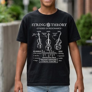 May include: A black short-sleeve t-shirt featuring a white graphic print titled String Theory Studies in Resonance. The design includes illustrations of a violin, viola, and bass, along with scientific text labels, a wave diagram, and equations.