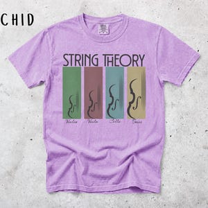 May include: A lilac t-shirt with the words "STRING THEORY" above four vertical rectangles. Each rectangle features a violin family instrument: violin, viola, cello, and bass. The shirt is a short-sleeved crew neck.