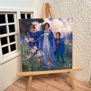 May include: Miniature painting on a wooden easel. The artwork depicts a scene with figures in blue gowns and a boy in blue, surrounded by white lilies and other flowers. The background shows a cloudy sky and a tree.