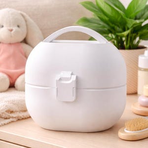 May include: A white ceramic mug with a black handle and the text "But First, Coffee" in a black, handwritten-style font. The mug is on a white surface.