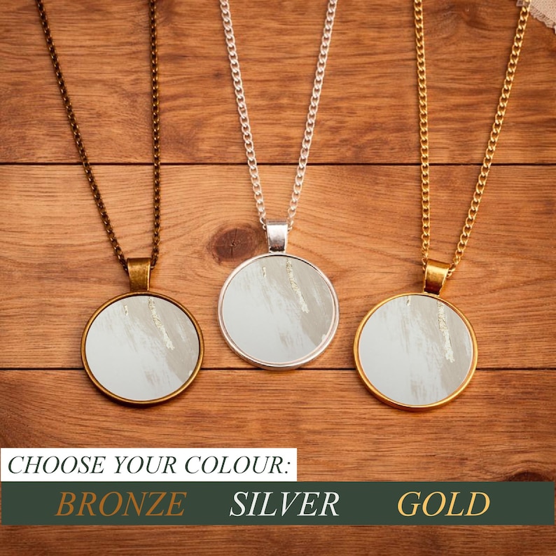 May include: Three pendant necklaces with circular, abstract art designs. The necklaces are bronze, silver, and gold. The text at the bottom reads "CHOOSE YOUR COLOUR: BRONZE SILVER GOLD."