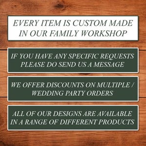 May include: Four rectangular signs with white text on a dark green background, set against a wooden backdrop. The signs state: "EVERY ITEM IS CUSTOM MADE IN OUR FAMILY WORKSHOP," "IF YOU HAVE ANY SPECIFIC REQUESTS PLEASE DO SEND US A MESSAGE," "WE OFFER DISCOUNTS ON MULTIPLE / WEDDING PARTY ORDERS," and "ALL OF OUR DESIGNS ARE AVAILABLE IN A RANGE OF DIFFERENT PRODUCTS."
