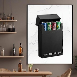 May include: A black box with an open lid, containing soda cans of various brands. The brands include Pepsi, Mountain Dew, Dr. Pepper, and Sprite. The box has the brand names printed on the front.