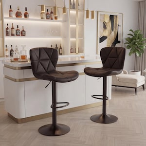 May include: Two brown bar stools with diamond-patterned seats and adjustable height. The stools have a dark brown base and footrest, suitable for a kitchen island or home bar. The background shows a bar area with liquor bottles and a decorative light fixture.