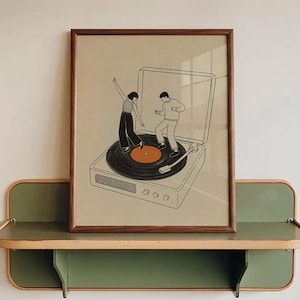 May include: A framed art print depicts two figures dancing on a record player. The artwork is in a minimalist style with black line drawings on a beige background. The frame is brown, and the print is displayed on a green and tan shelf.