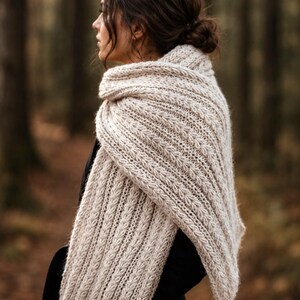Knitting pattern scarf folded on neutral background, cozy chunky knit accessory display. easy scarf knitting pattern, chunky knit scarf pattern. Warm wrap scarf knitting pattern, oversized women's knit scarf in worsted weight yarn, easy beginner cozy knit wrap PDF instant download. women knit scarf pattern, easy knitting pattern. rectangle scarf knit pattern. chunky heart scarf knit pattern