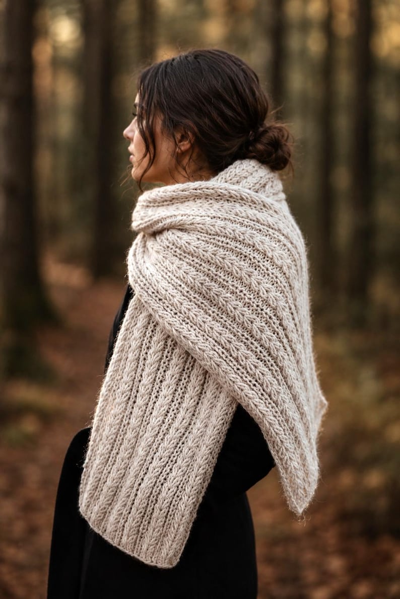 Knitting pattern scarf folded on neutral background, cozy chunky knit accessory display. easy scarf knitting pattern, chunky knit scarf pattern. Warm wrap scarf knitting pattern, oversized women's knit scarf in worsted weight yarn, easy beginner cozy knit wrap PDF instant download. women knit scarf pattern, easy knitting pattern. rectangle scarf knit pattern. chunky heart scarf knit pattern