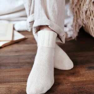 Knitting pattern pages close-up, basic socks knit instructions detail. basic socks knitting pattern. fold over socks knit pattern. easy knit women socks. top down knit socks pattern. cream white knit socks pattern. beginner socks knitting pattern. adult women knit socks pattern. classic knit socks.