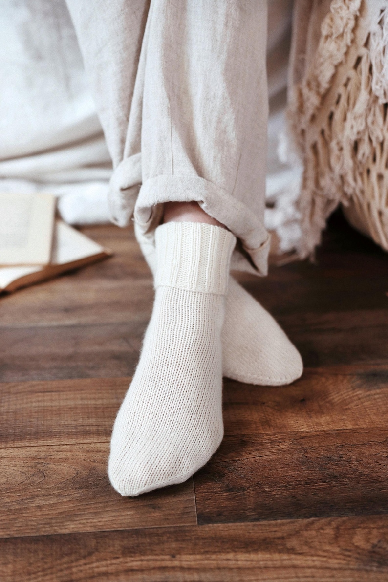 Knitting pattern pages close-up, basic socks knit instructions detail. basic socks knitting pattern. fold over socks knit pattern. easy knit women socks. top down knit socks pattern. cream white knit socks pattern. beginner socks knitting pattern. adult women knit socks pattern. classic knit socks.