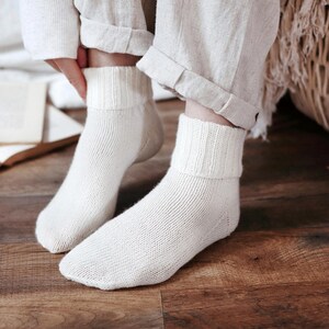 Knitting pattern pages close-up, basic socks knit instructions detail. basic socks knitting pattern. fold over socks knit pattern. easy knit women socks. top down knit socks pattern. cream white knit socks pattern. beginner socks knitting pattern. adult women knit socks pattern. classic knit socks.
