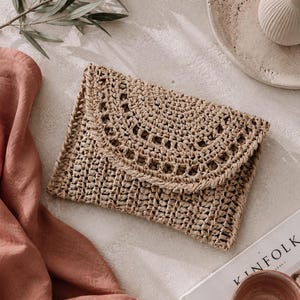 Raffia clutch crochet pattern, straw bag crochet pattern. crochet straw purse pattern. crochet raffia purse tote pattern. easy crochet purse. crochet tote handbag. straw summer bag crochet pattern. beginner crochet bag pattern.  Sunrise Clutch Crochet Pattern, Raffia Clutch Bag Crochet Pattern, Straw Summer Bag Crochet Pattern, Bag Crochet Pattern, Raffia Clutch Crochet Pattern, Summer Bag Crochet Pattern, Easy Crochet Patterns, Beginner Crochet Pattern, Tote Crochet Pattern