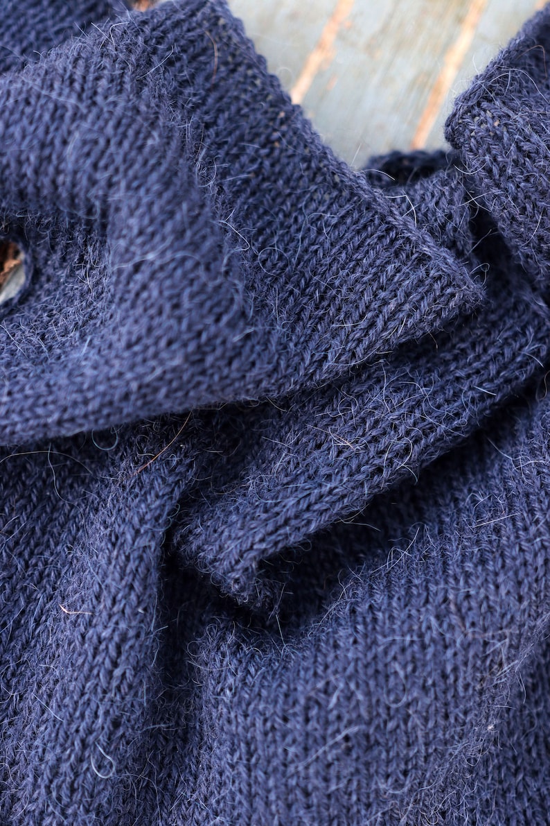 Closeup of a handknit blue scarf by Darling Jadore for a kerchief bandana scarf knitting patten. petite knit scarf knitting pattern by darling jadore