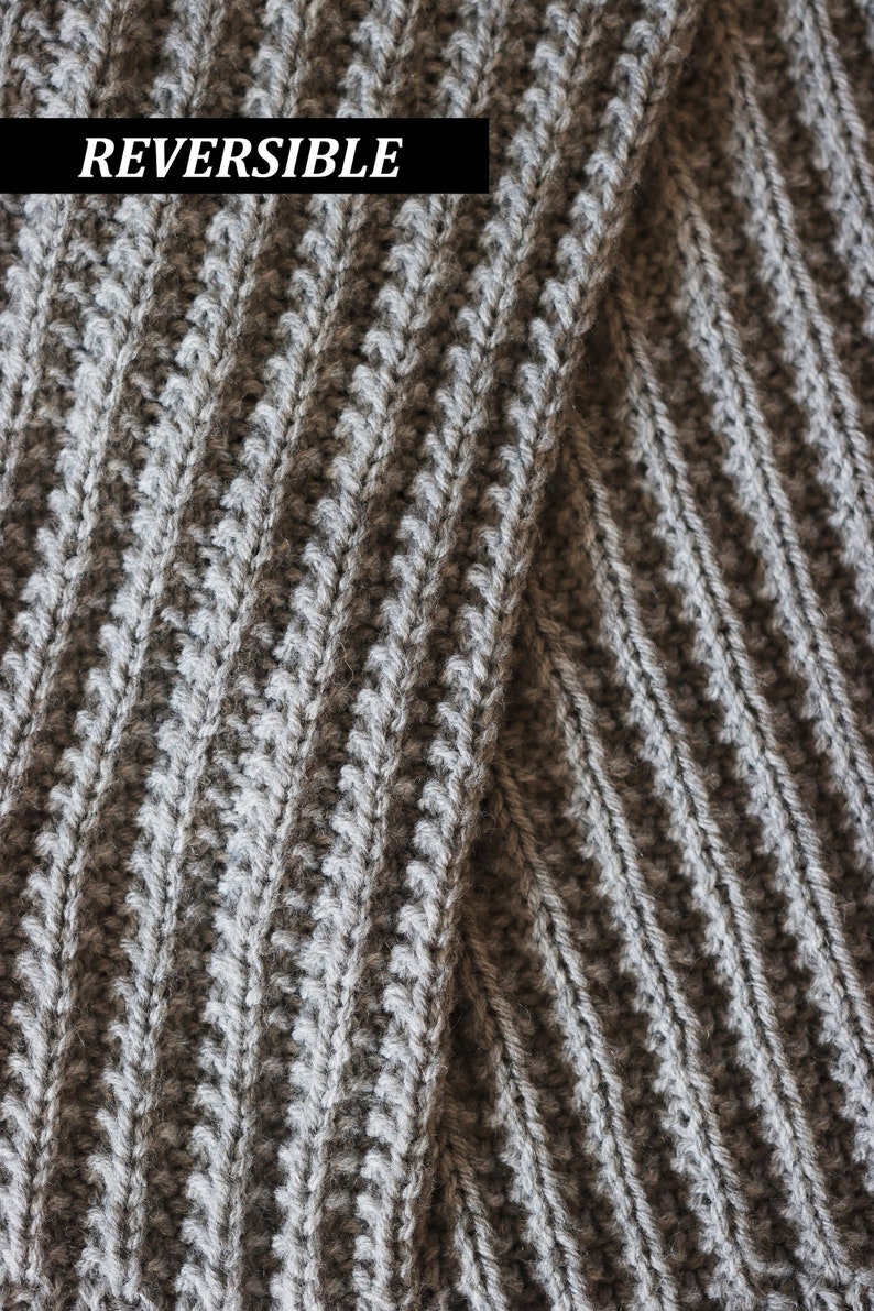 The cozy knitted texture of a knitted scarf, The Mountaineer Scarf, is shown. This men's ribbed knitted scarf was knit using gray yarn and is a great scarf for men.
[knitted scarf, men knit scarf, men scarf knitting pattern]