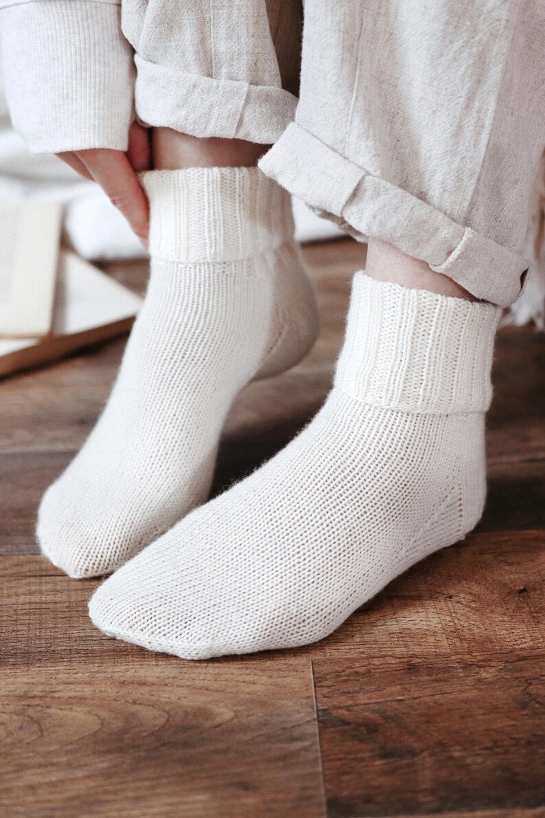 Knitting pattern pages close-up, basic socks knit instructions detail. basic socks knitting pattern. fold over socks knit pattern. easy knit women socks. top down knit socks pattern. cream white knit socks pattern. beginner socks knitting pattern. adult women knit socks pattern. classic knit socks.