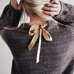 Beginner sweater knitting pattern, oversized top-down raglan pullover in worsted weight yarn, women's seamless crewneck knit jumper. ribbon tie knit sweater pattern. oversize raglan jumper pattern for women