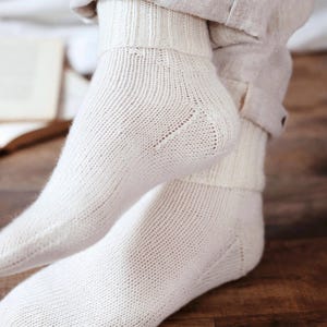 Knitting pattern pages close-up, basic socks knit instructions detail. basic socks knitting pattern. fold over socks knit pattern. easy knit women socks. top down knit socks pattern. cream white knit socks pattern. beginner socks knitting pattern. adult women knit socks pattern. classic knit socks.