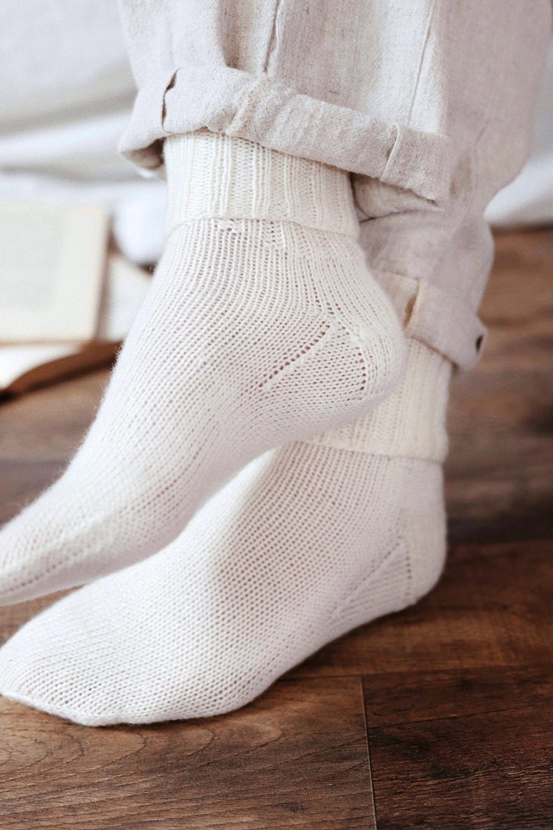 Knitting pattern pages close-up, basic socks knit instructions detail. basic socks knitting pattern. fold over socks knit pattern. easy knit women socks. top down knit socks pattern. cream white knit socks pattern. beginner socks knitting pattern. adult women knit socks pattern. classic knit socks.