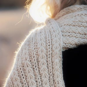 Knitting pattern scarf folded on neutral background, cozy chunky knit accessory display. easy scarf knitting pattern, chunky knit scarf pattern. Warm wrap scarf knitting pattern, oversized women's knit scarf in worsted weight yarn, easy beginner cozy knit wrap PDF instant download. women knit scarf pattern, easy knitting pattern. rectangle scarf knit pattern. chunky heart scarf knit pattern