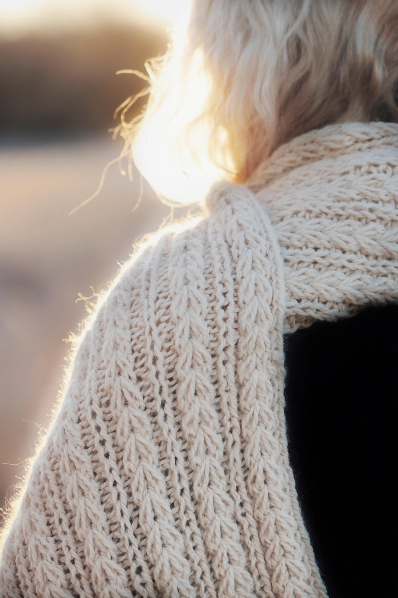 Knitting pattern scarf folded on neutral background, cozy chunky knit accessory display. easy scarf knitting pattern, chunky knit scarf pattern. Warm wrap scarf knitting pattern, oversized women's knit scarf in worsted weight yarn, easy beginner cozy knit wrap PDF instant download. women knit scarf pattern, easy knitting pattern. rectangle scarf knit pattern. chunky heart scarf knit pattern
