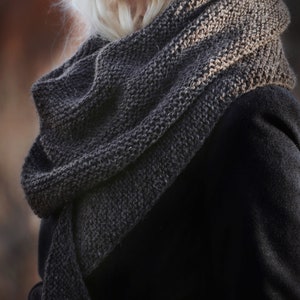 Woman wearing a hand knitted scarf, easy knitting pattern for a fall scarf.