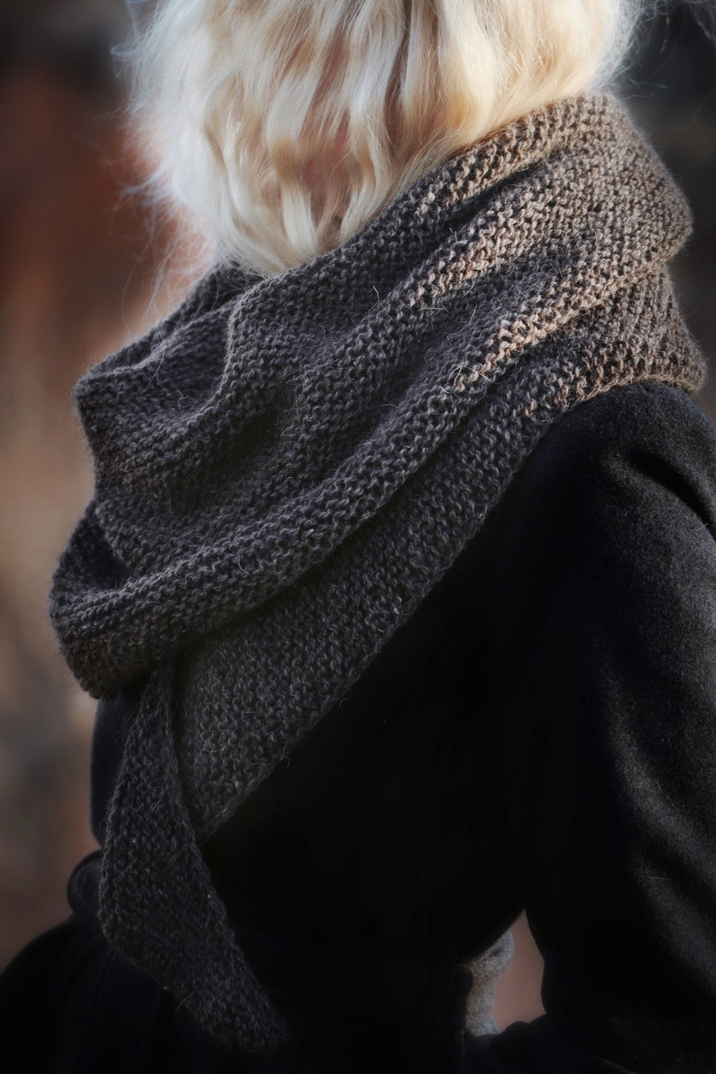 Woman wearing a hand knitted scarf, easy knitting pattern for a fall scarf.