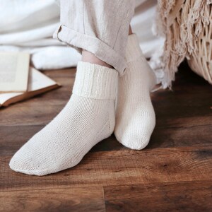 Knitting pattern pages close-up, basic socks knit instructions detail. basic socks knitting pattern. fold over socks knit pattern. easy knit women socks. top down knit socks pattern. cream white knit socks pattern. beginner socks knitting pattern. adult women knit socks pattern. classic knit socks.