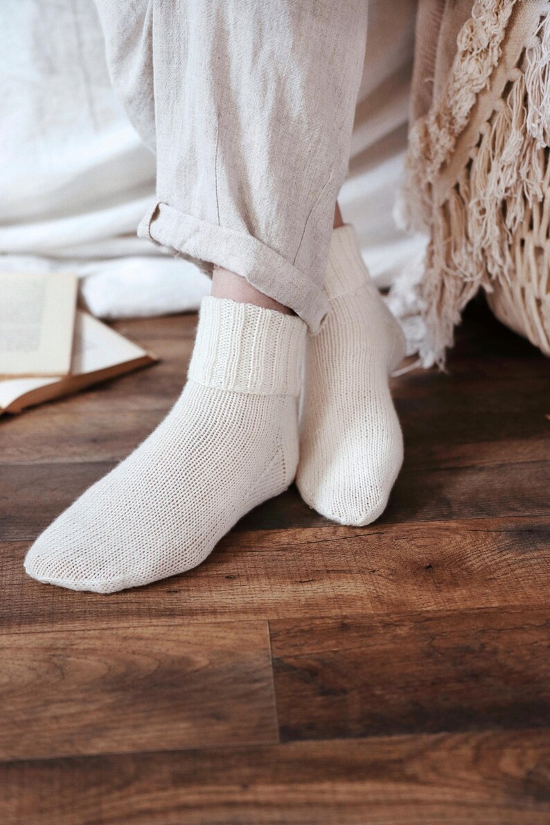 Knitting pattern pages close-up, basic socks knit instructions detail. basic socks knitting pattern. fold over socks knit pattern. easy knit women socks. top down knit socks pattern. cream white knit socks pattern. beginner socks knitting pattern. adult women knit socks pattern. classic knit socks.