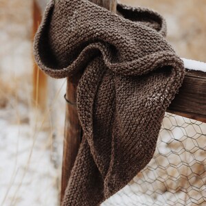 Beginner scarf knitting pattern, easy classic women's knit scarf in worsted weight yarn. Boomerang knit scarf pattern. simple beginner knit wrap PDF instant download. Beginner scarf shawl knitting pattern by Darling Jadore. it's a boomerang asymmetrical shawl knitting pattern designed for beginners. Brown scarf knitting pattern garter stitich easy knitting pattern by Darling Jadore