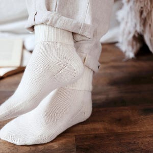 Knitting pattern pages close-up, basic socks knit instructions detail. basic socks knitting pattern. fold over socks knit pattern. easy knit women socks. top down knit socks pattern. cream white knit socks pattern. beginner socks knitting pattern. adult women knit socks pattern. classic knit socks.