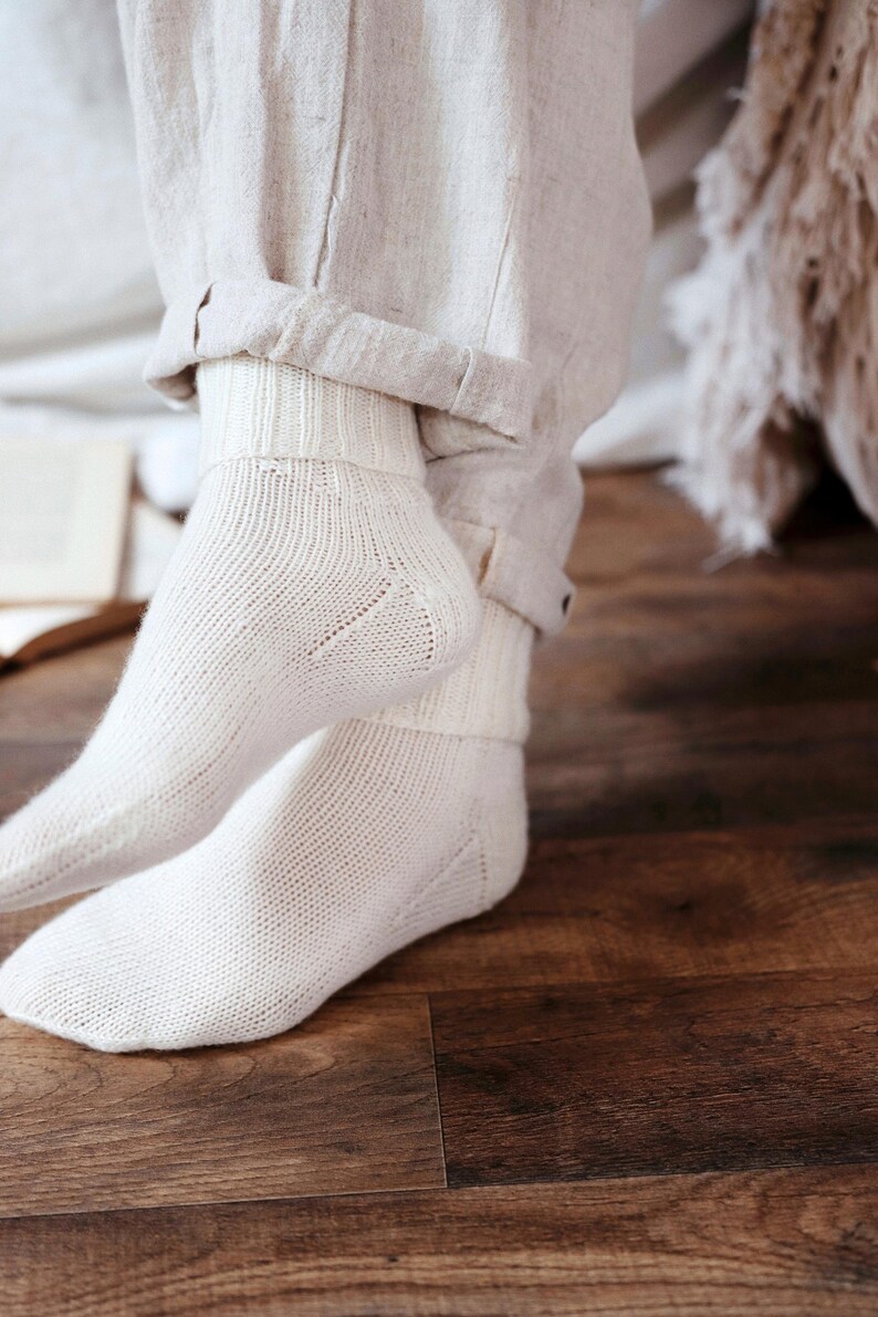 Knitting pattern pages close-up, basic socks knit instructions detail. basic socks knitting pattern. fold over socks knit pattern. easy knit women socks. top down knit socks pattern. cream white knit socks pattern. beginner socks knitting pattern. adult women knit socks pattern. classic knit socks.