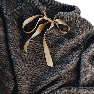 Close-up of seamless raglan construction on oversized beginner pullover, top-down knitting pattern Beginner sweater knitting pattern, oversized top-down raglan pullover in worsted weight yarn, women's seamless crewneck knit jumper. ribbon tie knit sweater pattern. oversize raglan jumper pattern for women