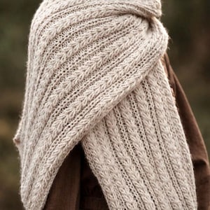 Knitting pattern scarf folded on neutral background, cozy chunky knit accessory display. easy scarf knitting pattern, chunky knit scarf pattern. Warm wrap scarf knitting pattern, oversized women's knit scarf in worsted weight yarn, easy beginner cozy knit wrap PDF instant download. women knit scarf pattern, easy knitting pattern. rectangle scarf knit pattern. chunky heart scarf knit pattern